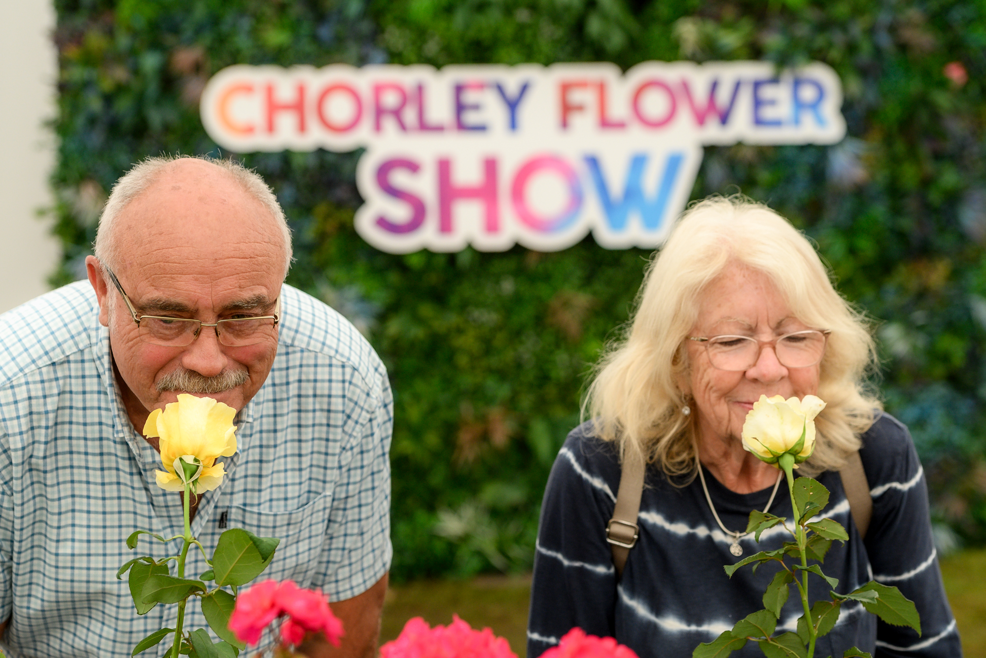 people smelling roses