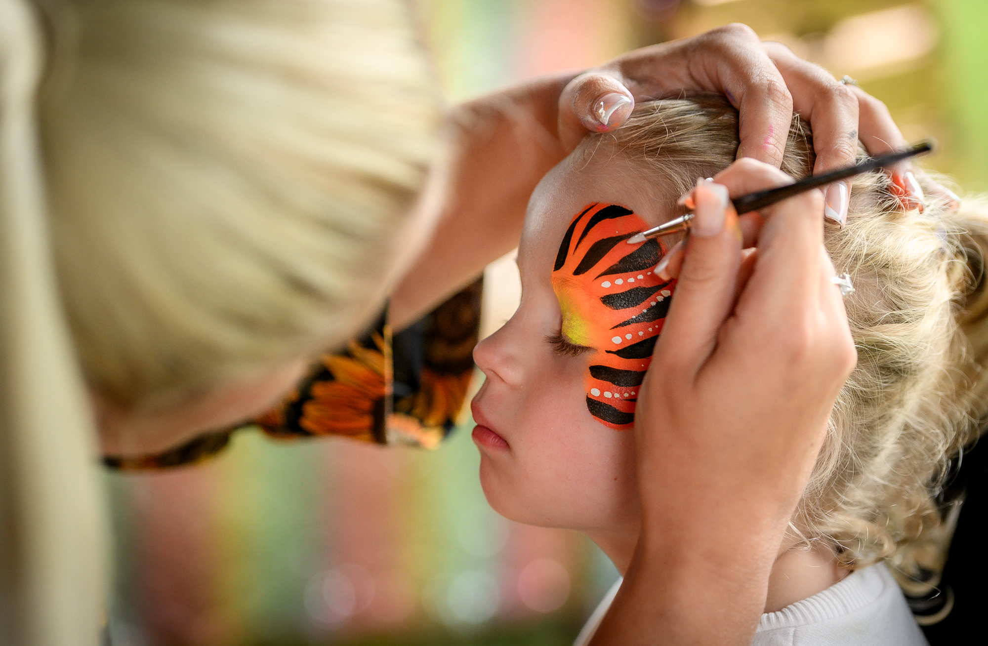 Child having their face painte